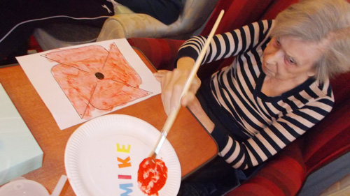 female care client enjoying the activity of painting